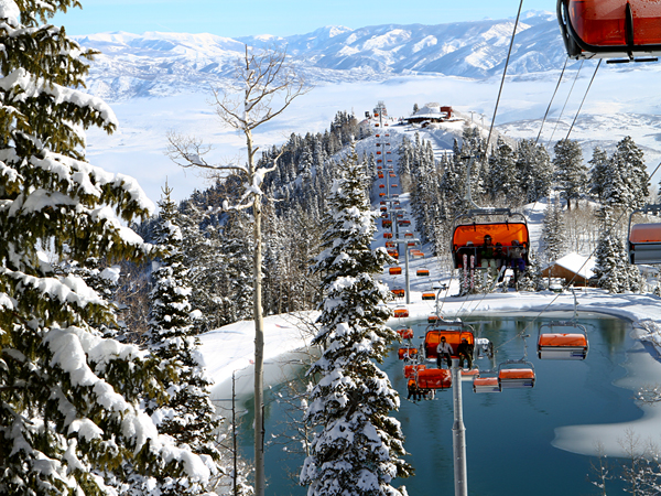 Orange lift chairs rise over the Canyons Resort in Park City, Utah